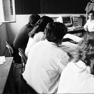 Classroom with students using early computer terminals.