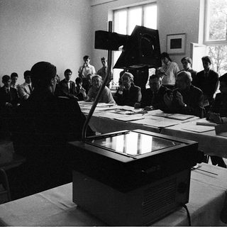 Classroom lecture with projector and seated students.