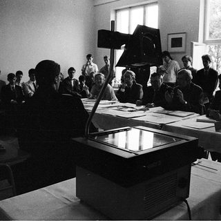 Classroom lecture with projector and seated students.