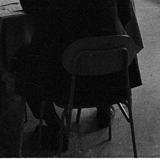 Classroom discussion or lecture with students seated at tables.