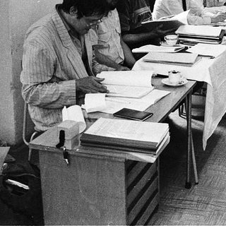 Group meeting with attendees reviewing documents at tables.