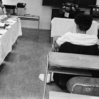 Group meeting with attendees reviewing documents at tables.