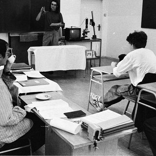 Classroom lecture with professor teaching students.