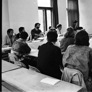 Classroom lecture with students seated at desks.