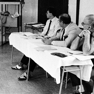 Business meeting with early computer demonstration.