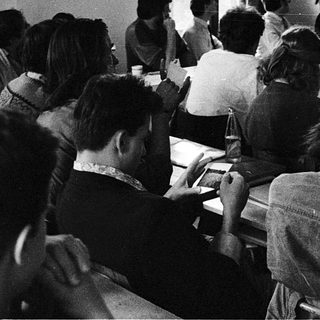 Classroom lecture with audience facing projector slide.