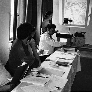 Group of men attending a formal meeting with projector.