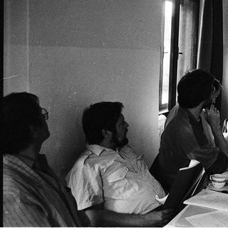 Group of men attending a formal meeting with projector.