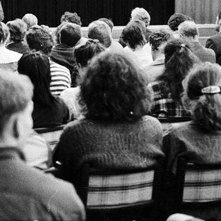 People attending a lecture or meeting in 1994.