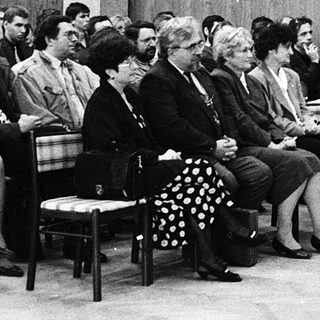 Formal indoor meeting or conference with speaker addressing audience.
