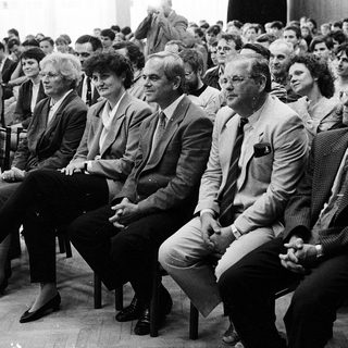 Group of people attending formal indoor event.