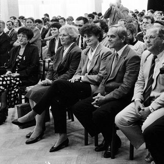 Group of people attending formal indoor event.
