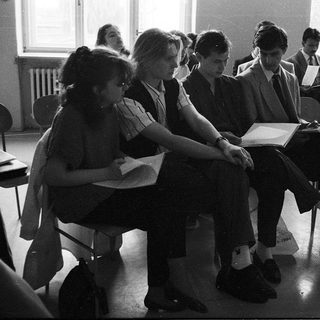 Students sitting in exam with open books.