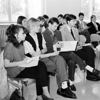 Group of students attending a formal lecture or meeting.