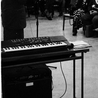 Concert or lecture hall with audience and performer.