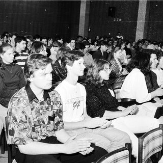Large audience attending indoor lecture or event.