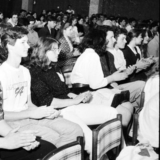 Large audience attending indoor lecture or event.