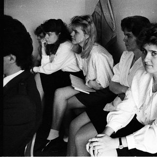 Group of women sitting together indoors, dressed in 1970s-80s style.