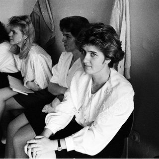 Group of women sitting together indoors, dressed in 1970s-80s style.
