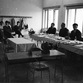 Classroom setting with students writing at desks during a typing lesson.