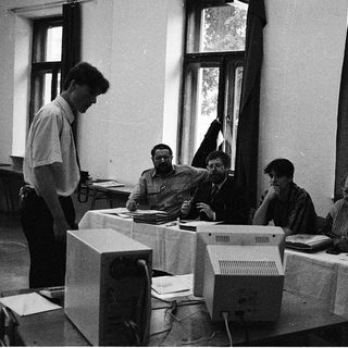 Group using early desktop computers in classroom setting.