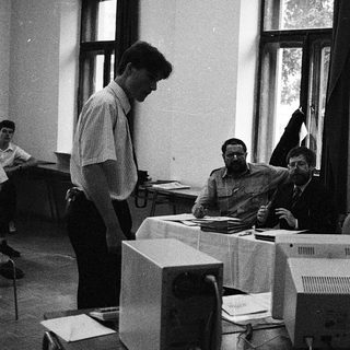Group using early desktop computers in classroom setting.