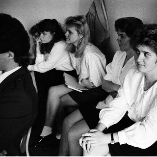 Group of people sitting indoors, mid-1970s to 1980s.