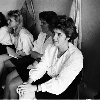 Group of people sitting indoors, mid-1970s to 1980s.