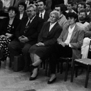 A formal lecture or conference with speaker and seated audience.