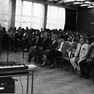 A speaker addresses an audience during a formal indoor event.