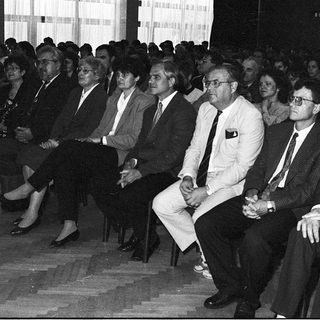 Formal gathering of men in suits attending an indoor event.