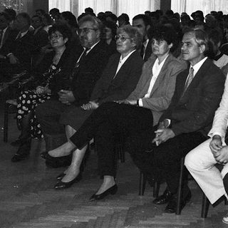 Formal gathering of men in suits attending an indoor event.