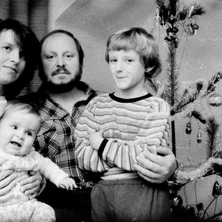 Family portrait with parents and two children during holiday season.