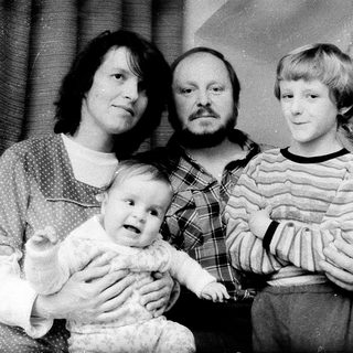 Family portrait with parents and two children during holiday season.