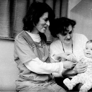 Family posing with baby near Christmas tree.