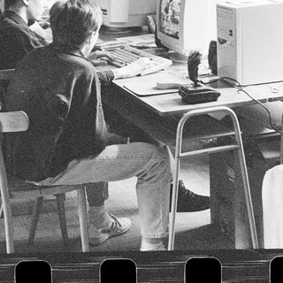 Classroom with students using early desktop computers.