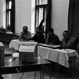 Early computer training session with instructor and students.