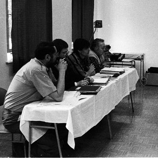 Meeting or presentation with attendees and a speaker.