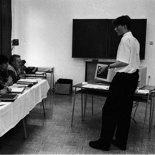 Meeting or presentation with attendees and a speaker.