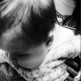 Tender moment of child hugging adult.