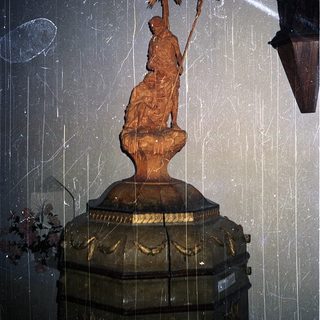 Gilded statue of Saint John the Baptist holding cross.