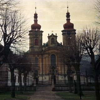 Baroque church with twin towers, winter scene.