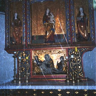 Elaborate religious shrine with gilded statues and intricate carvings.