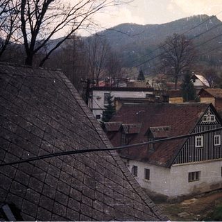 Rural village house with mountains in winter.