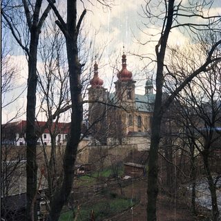 Baroque church through winter trees.