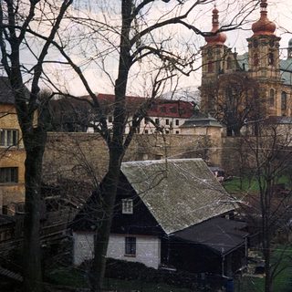 Baroque church with twin towers in winter landscape.