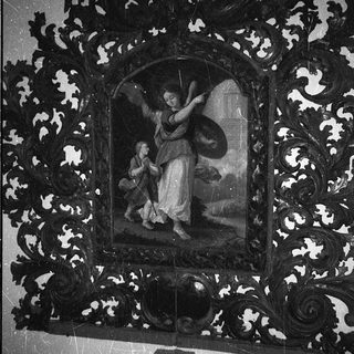 "Religious painting of angel and child in ornate frame."