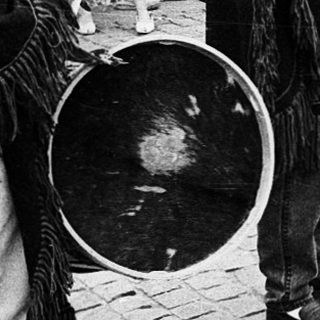 Street musicians performing traditional folk music outdoors.