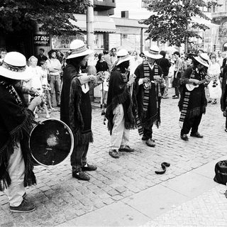 Street musicians performing traditional folk music outdoors.