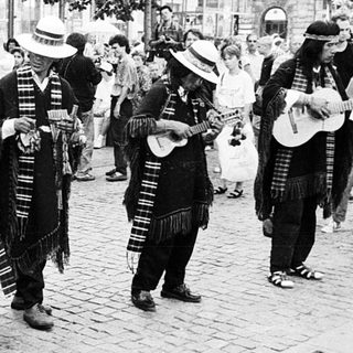 Street musicians performing traditional folk music outdoors.